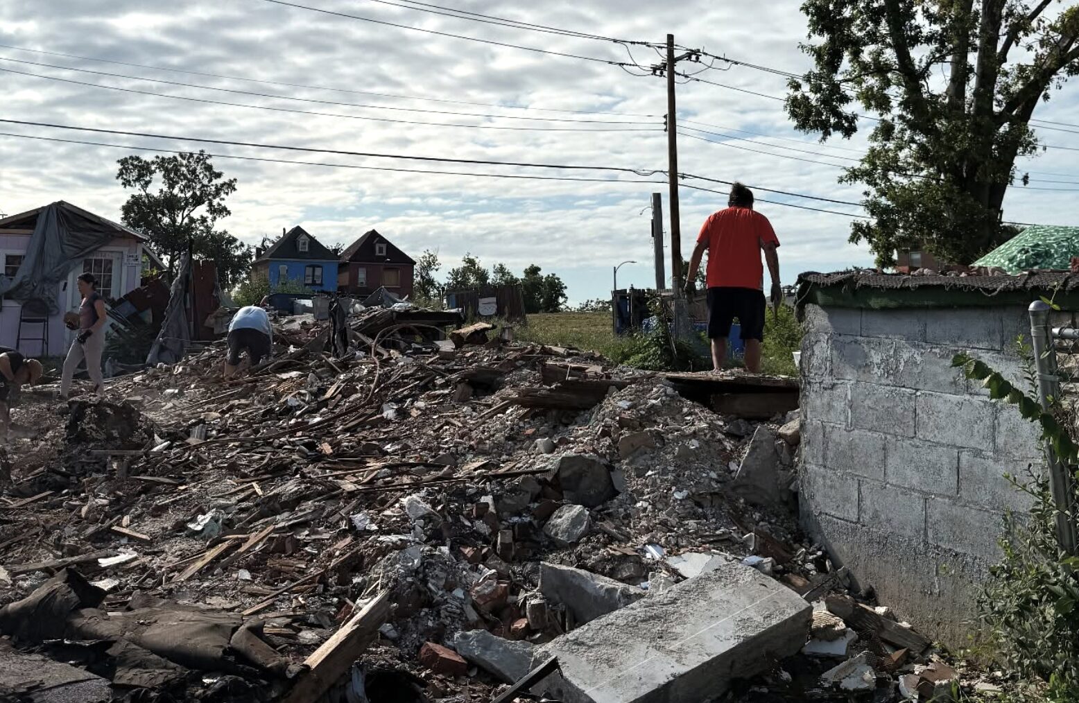 Volunteers and residents helping clean up damage from a tornado.